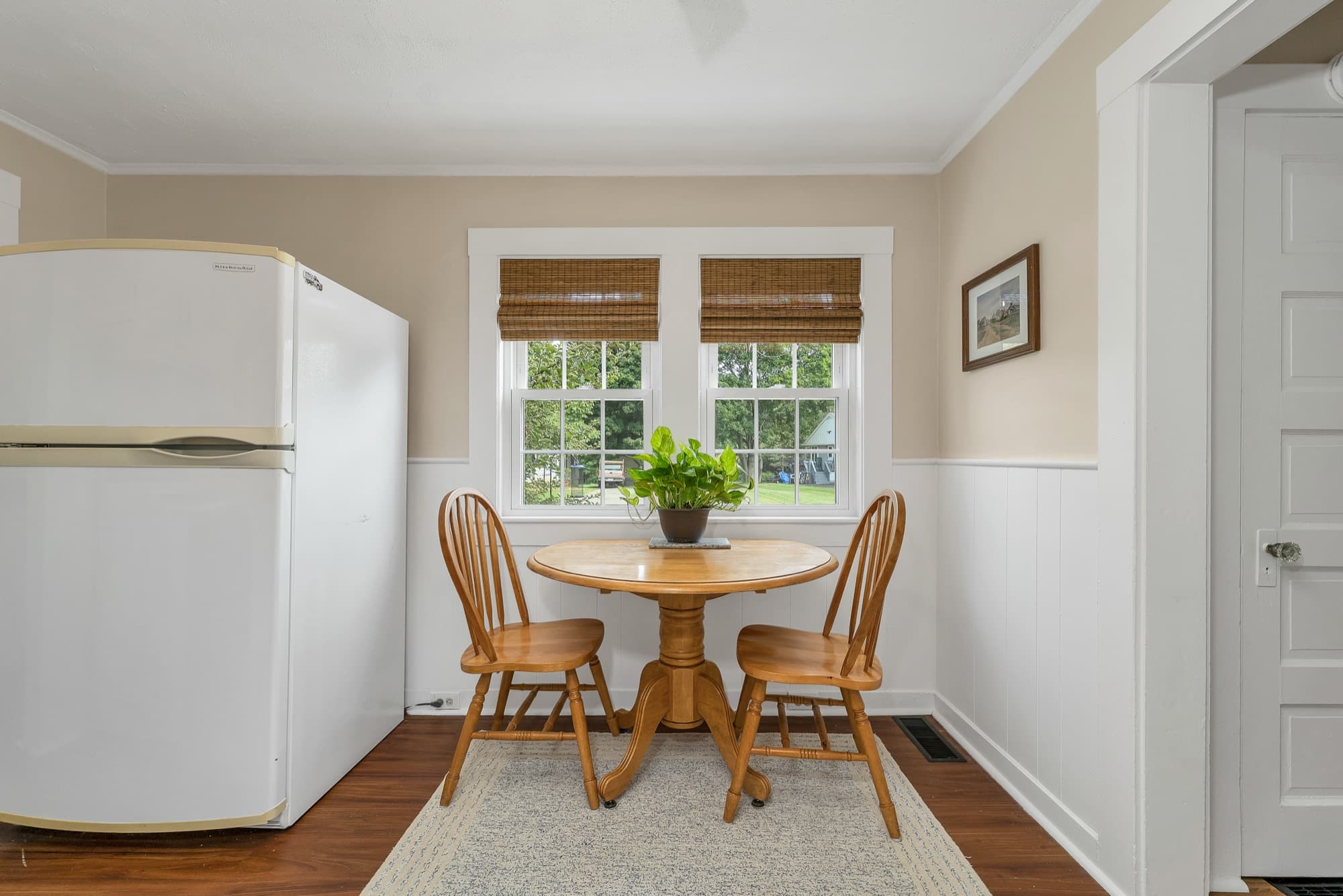 Unit 25 dining nook with a round table by the windows