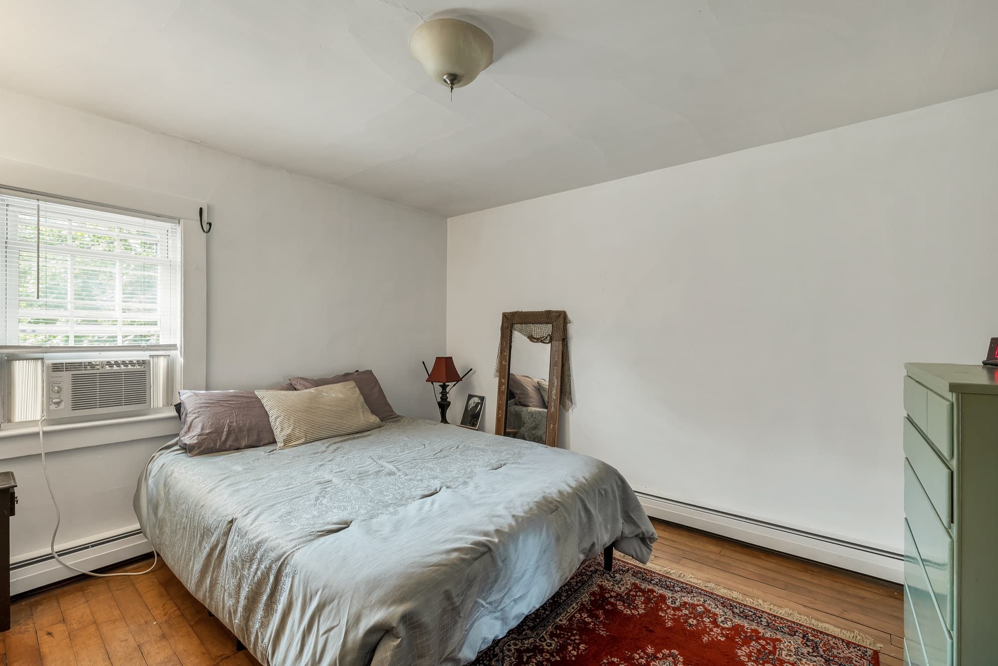 Unit 23 bedroom with wide-plank wood floors