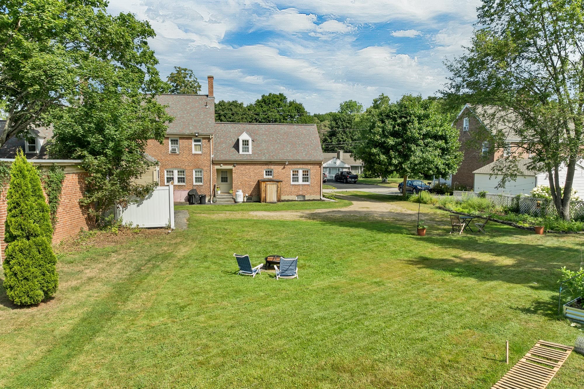 The level back lawn behind the house, with lawn chairs set out